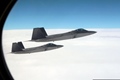 F-22 Raptors above clouds